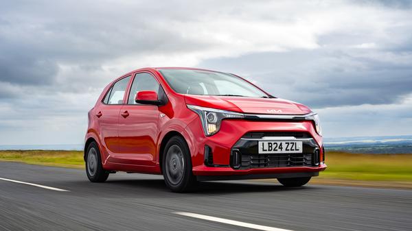 Red Kia Picanto driving on road