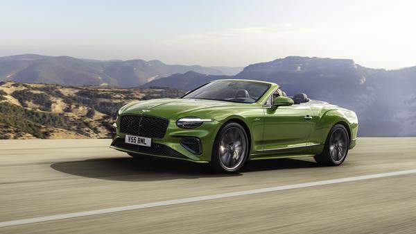 Green Bentley Continental GT Speed Convertible driving on an open road